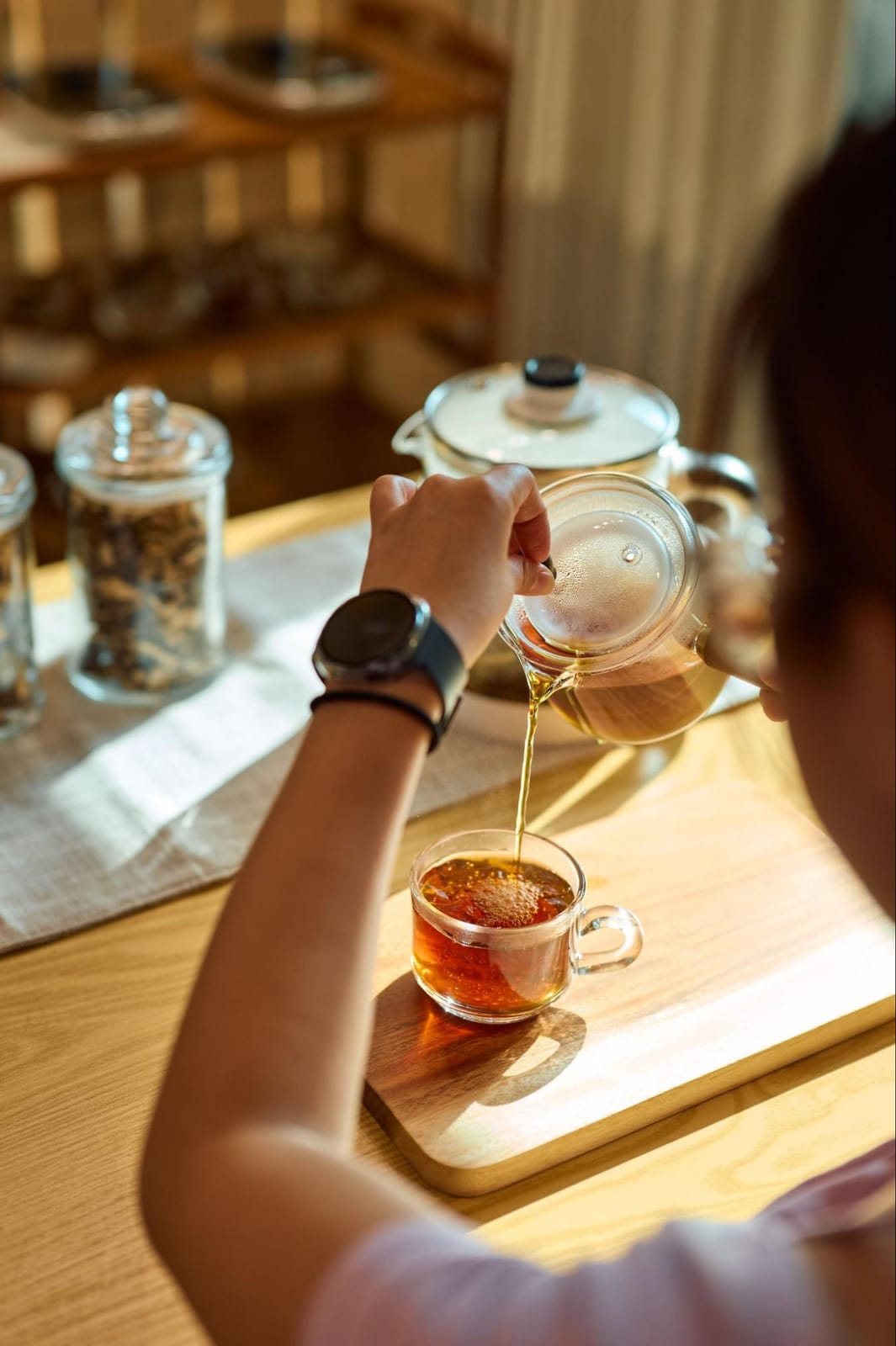 Pouring freshly brewed herbal tea